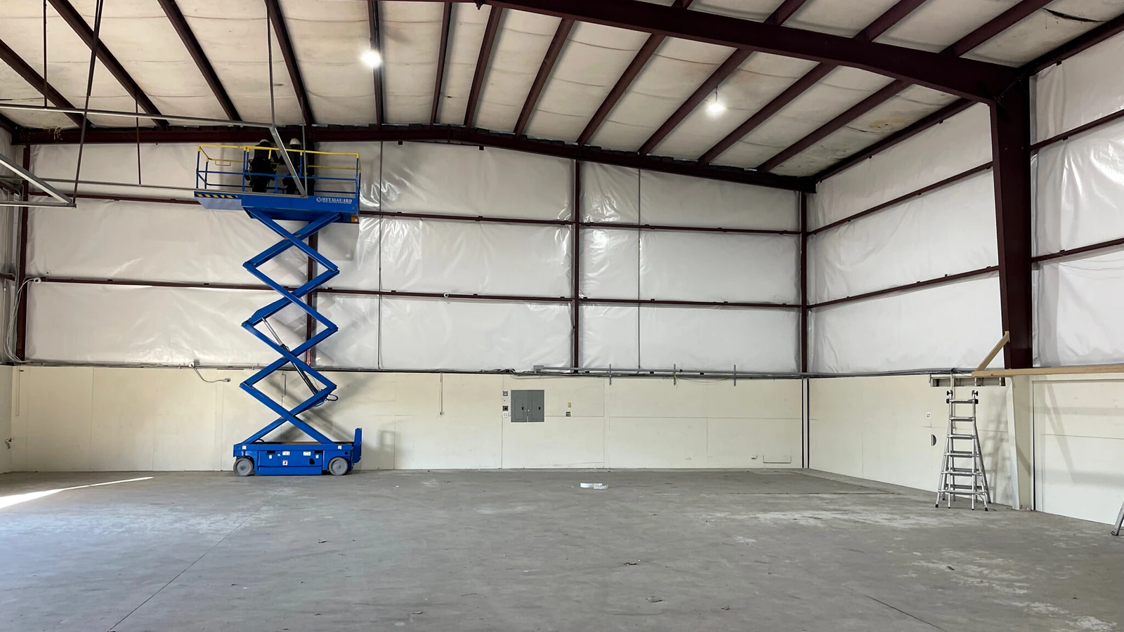Steel building insulation in a metal-framed warehouse