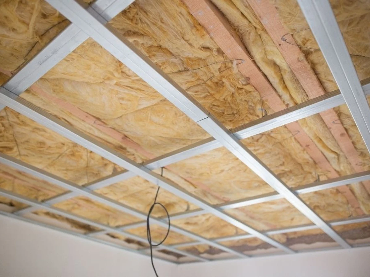 Fibrous insulation installed within ceiling framing